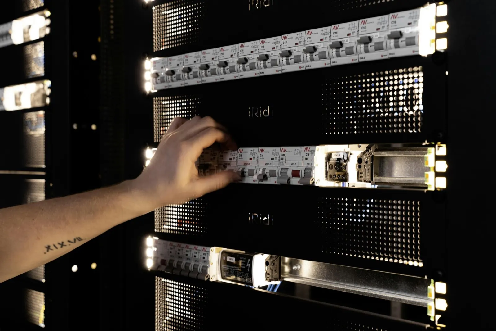 A technician adjusting equipment in a server rack
